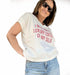 Female model wearing a white cotton V-neck t-shirt with red text saying 'I'm a limited luxury edition of my self'.